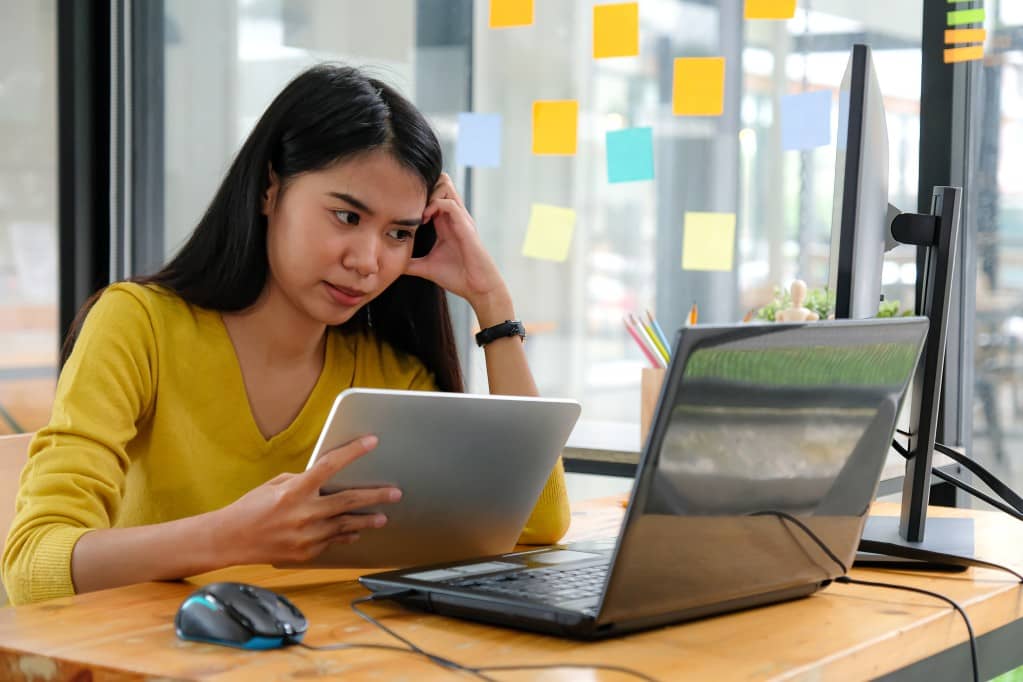 A female office entrepreneur in a coworking space, not having to worry about multiple bills for the office. 