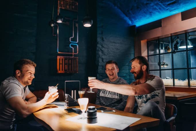 Three friends enjoying building a product together inside a flexible office space.