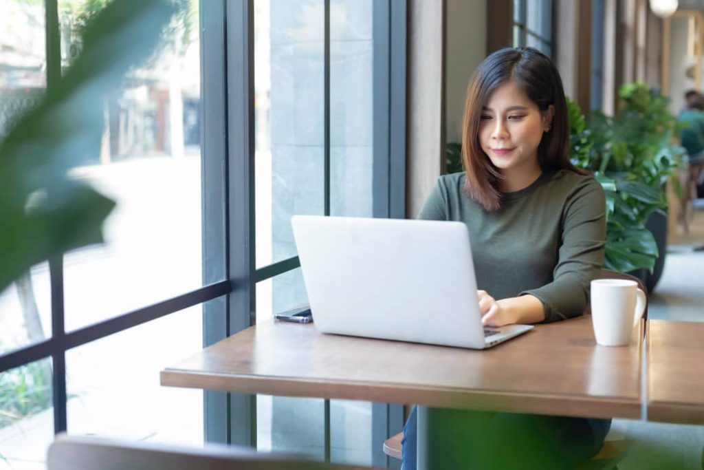 Asian woman working in a CBD coworking office location.