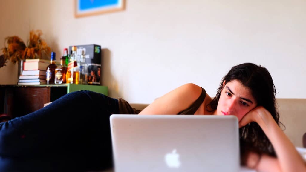 Girl laying on the couch trying to improve work efficiency.