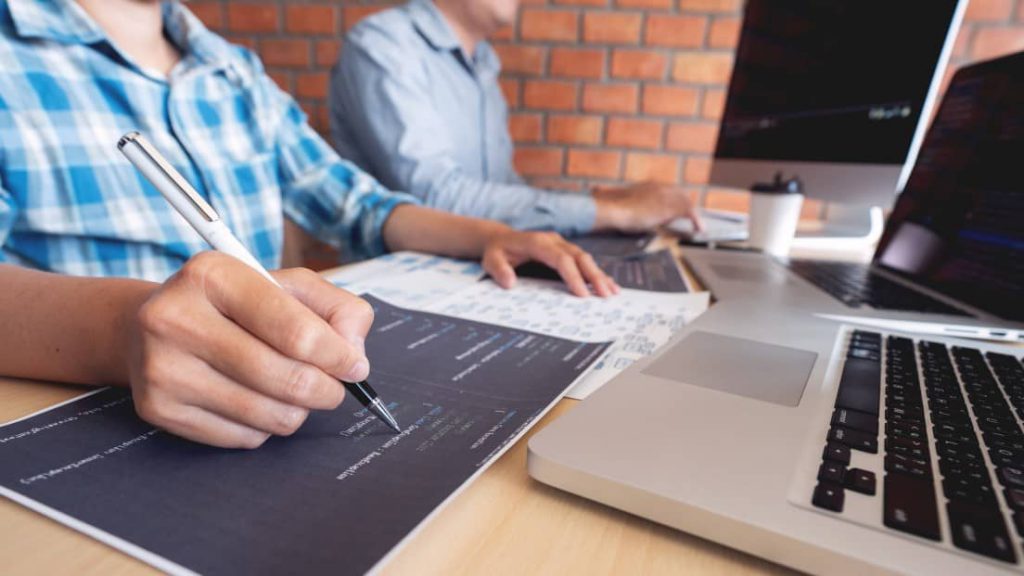 Two coworkers working in a coworking space outside office times.