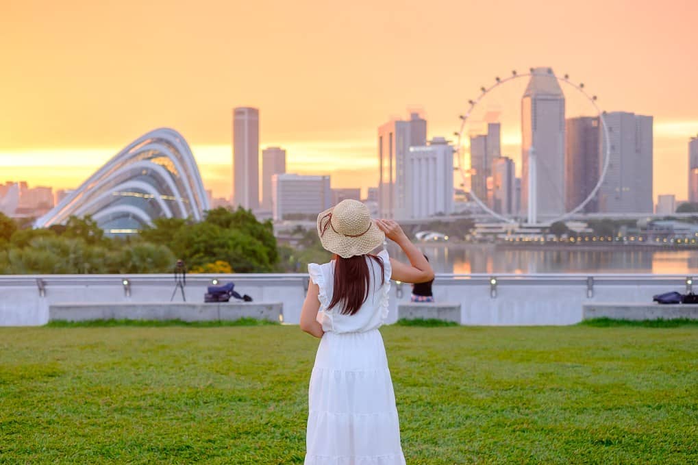 Happy woman in Singapore looking over the office landscape.