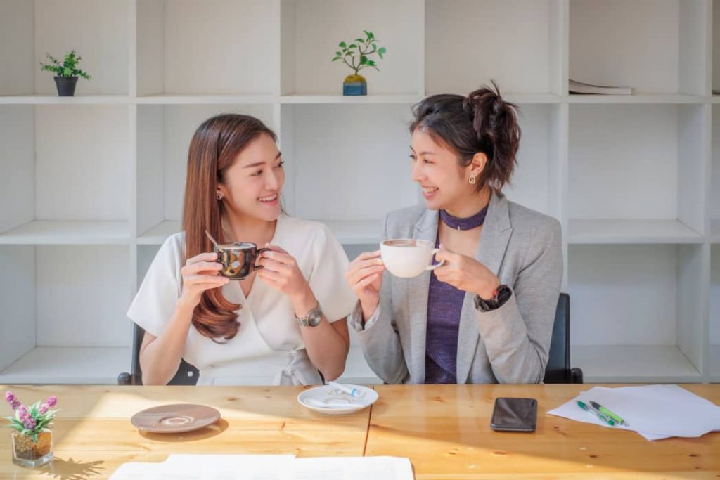 Two workers participating in light tea and coffee.