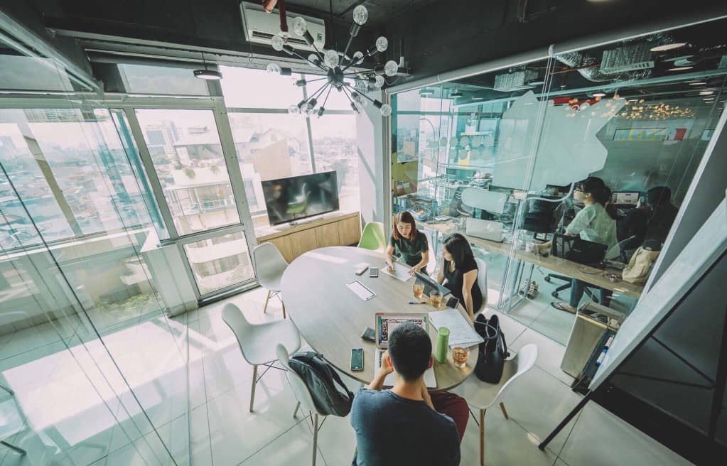 Group of office workers with desks available to grow.