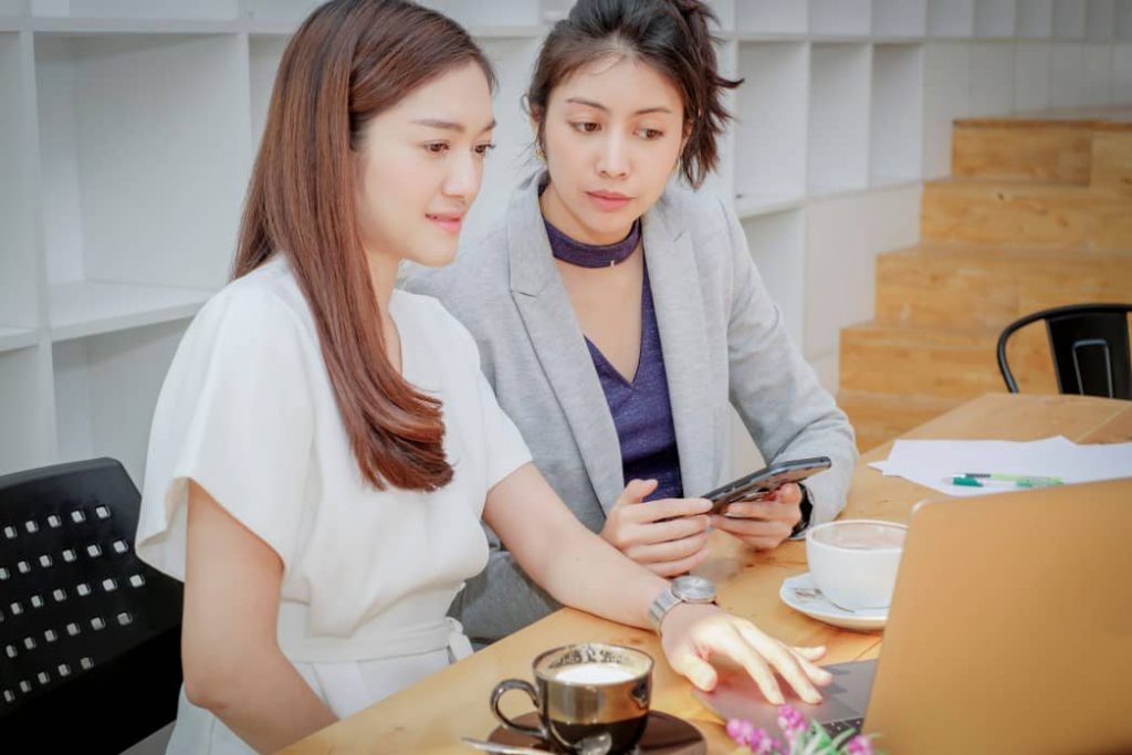 Two office workers collaborating in a flexible office environment.