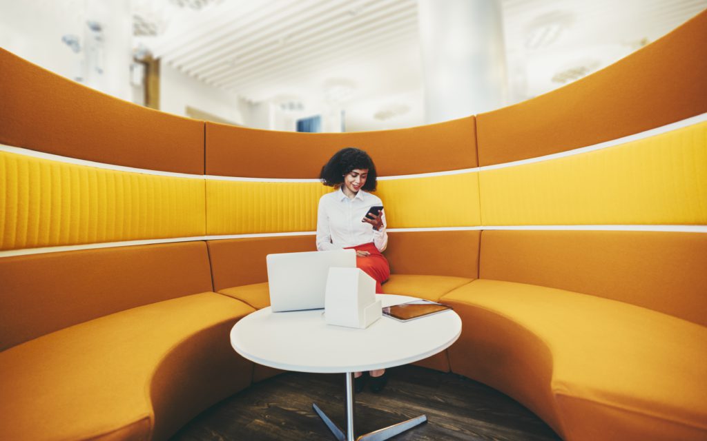 a wide angle shot of a young elegant african american businesswoman using her smartphone and gadgets t20 kLQ7ER scaled