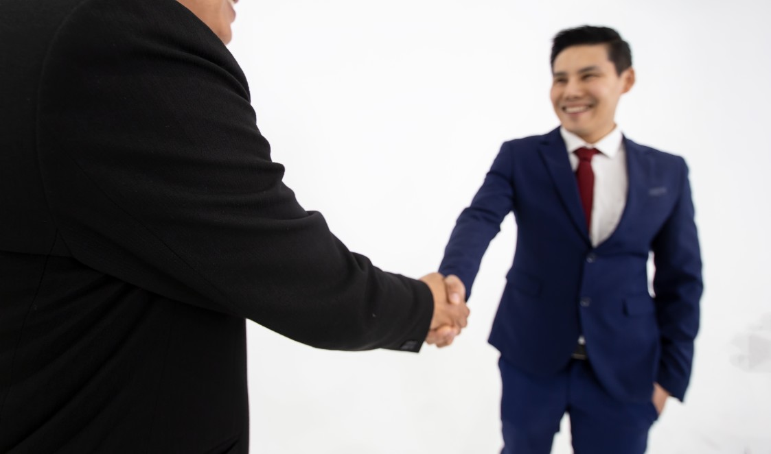 new employee handshake with colleague