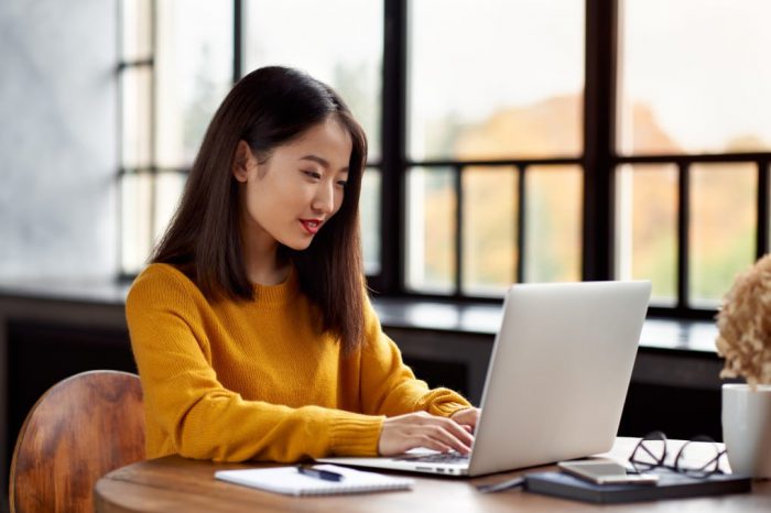 asian-woman-working-on-laptop-at-home-or-in-cafe-young-lady-in-bright-yellow-jumper-is-sitting-at_t20_JoBRJO office space for rent or lease in singapore